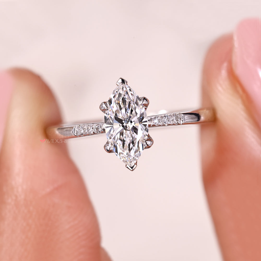 Handmade ring featuring marquise diamond and round cut side stones.