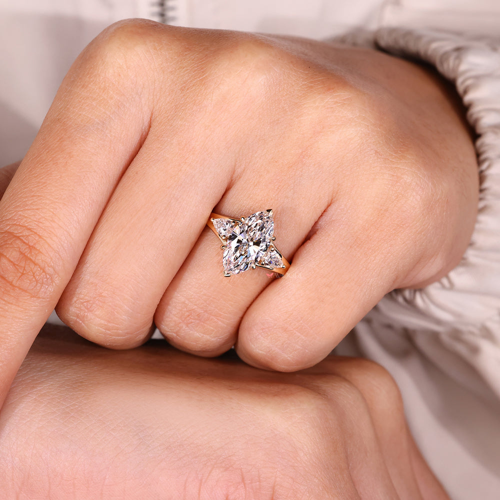Custom diamond ring with marquise center stone.