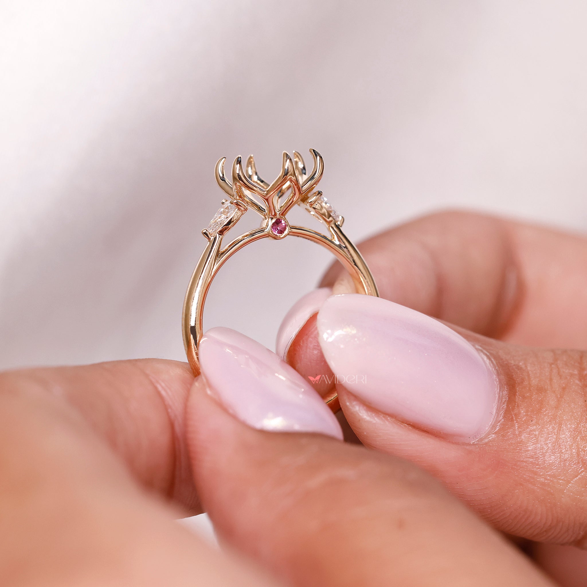 Pear side stone engagement ring featuring lab grown diamond and tapered shank design.
