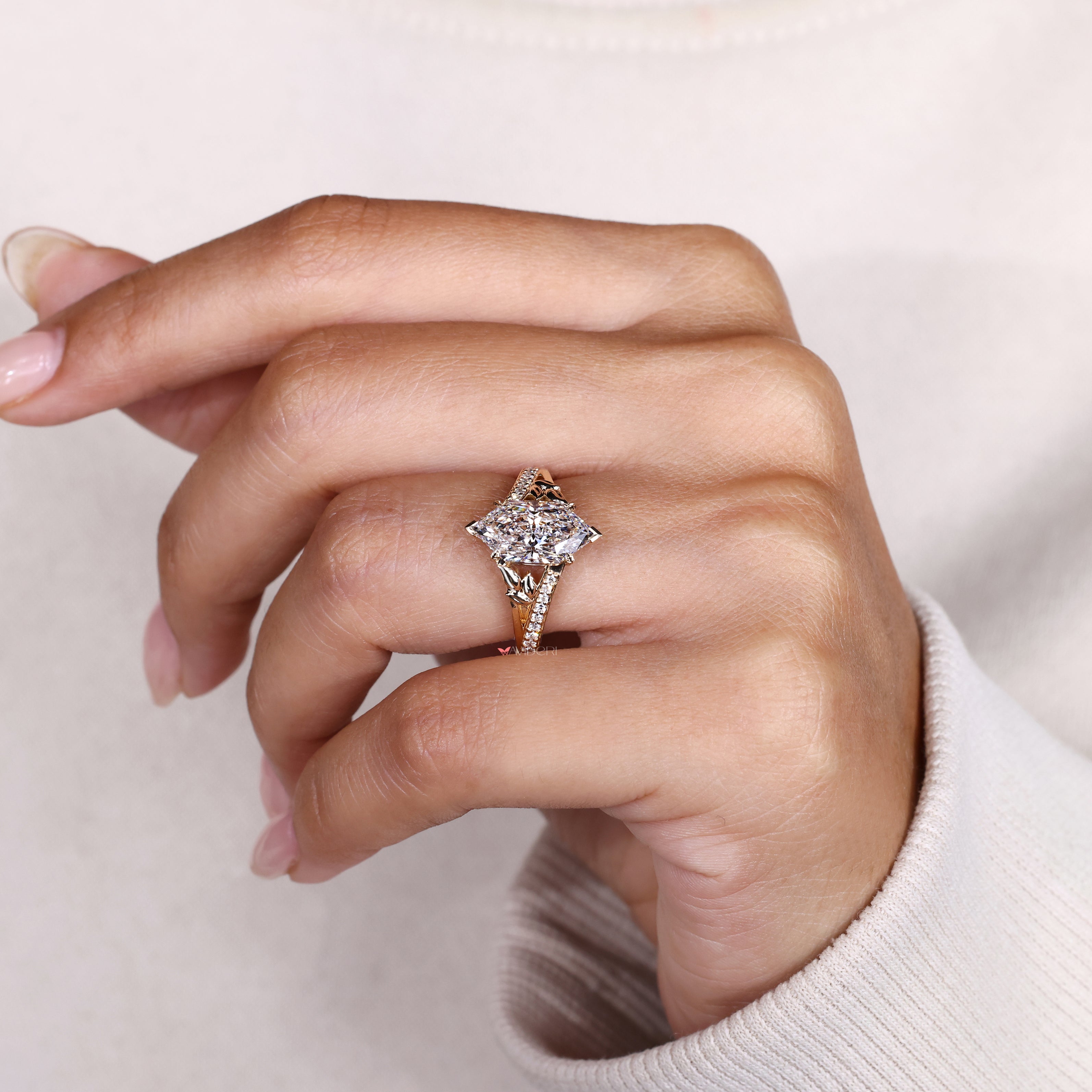 Marquise diamond ring with four leaf style prongs.
