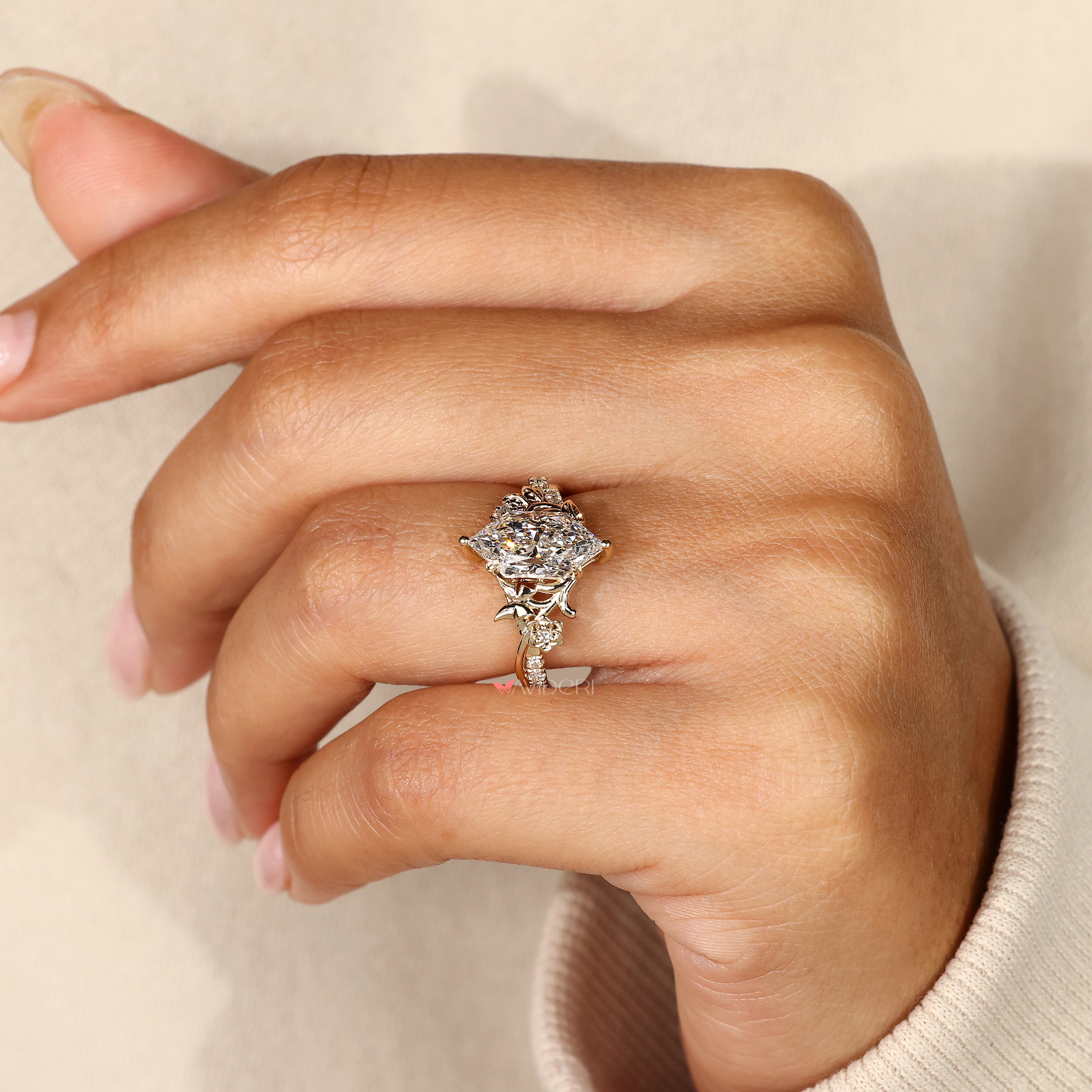 Marquise diamond ring with floral detailing and pave.
