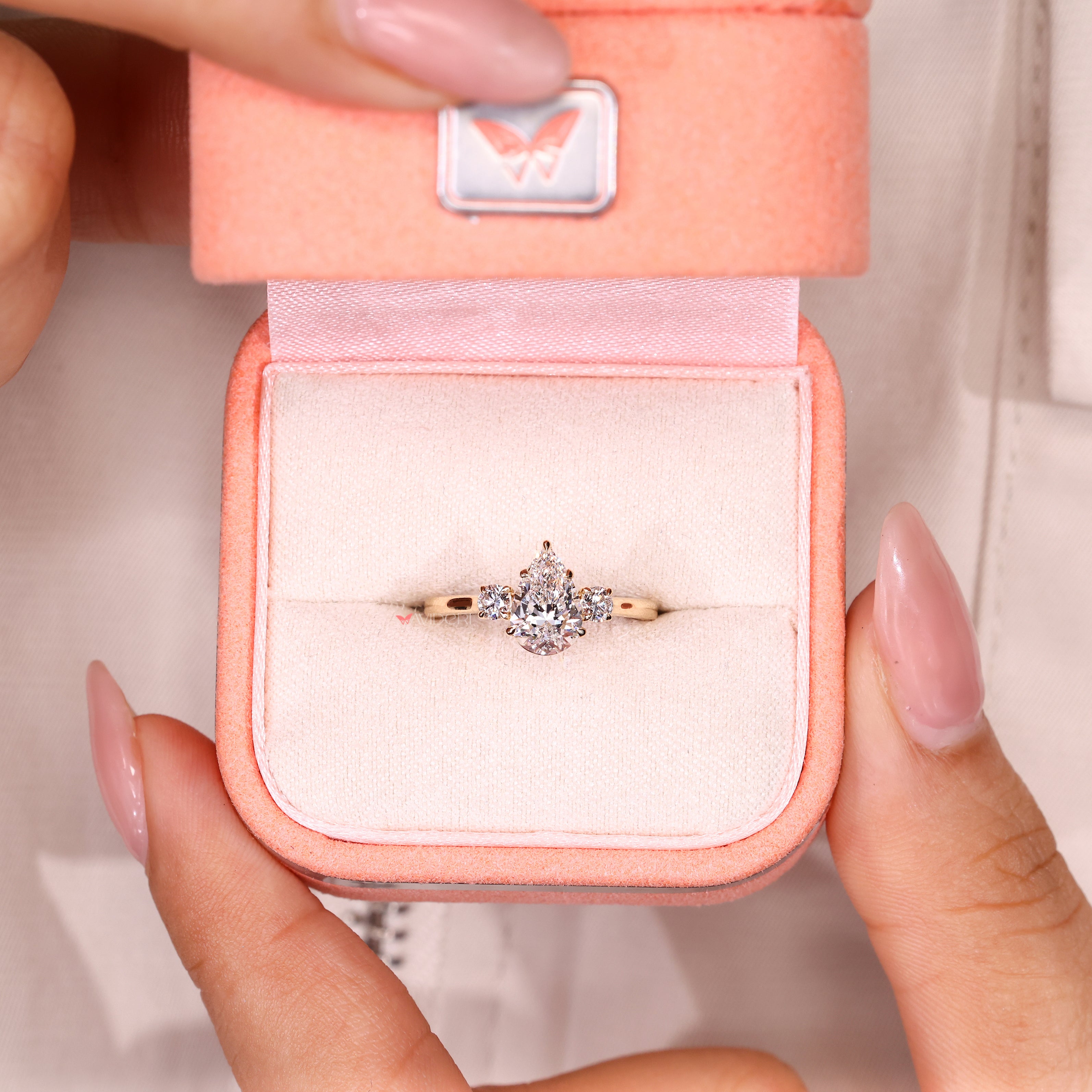 Three stone pear diamond ring with secure claw prongs
