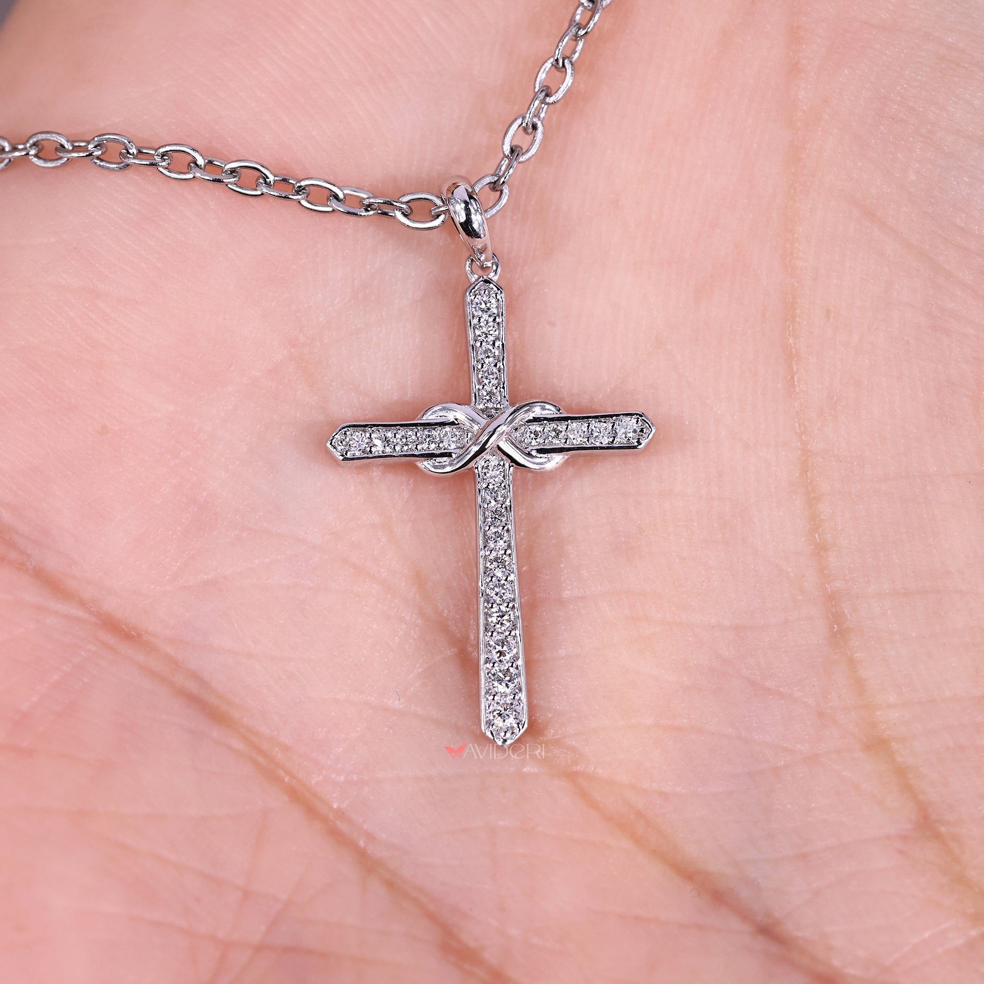 Diamond pendant featuring a cross shape.