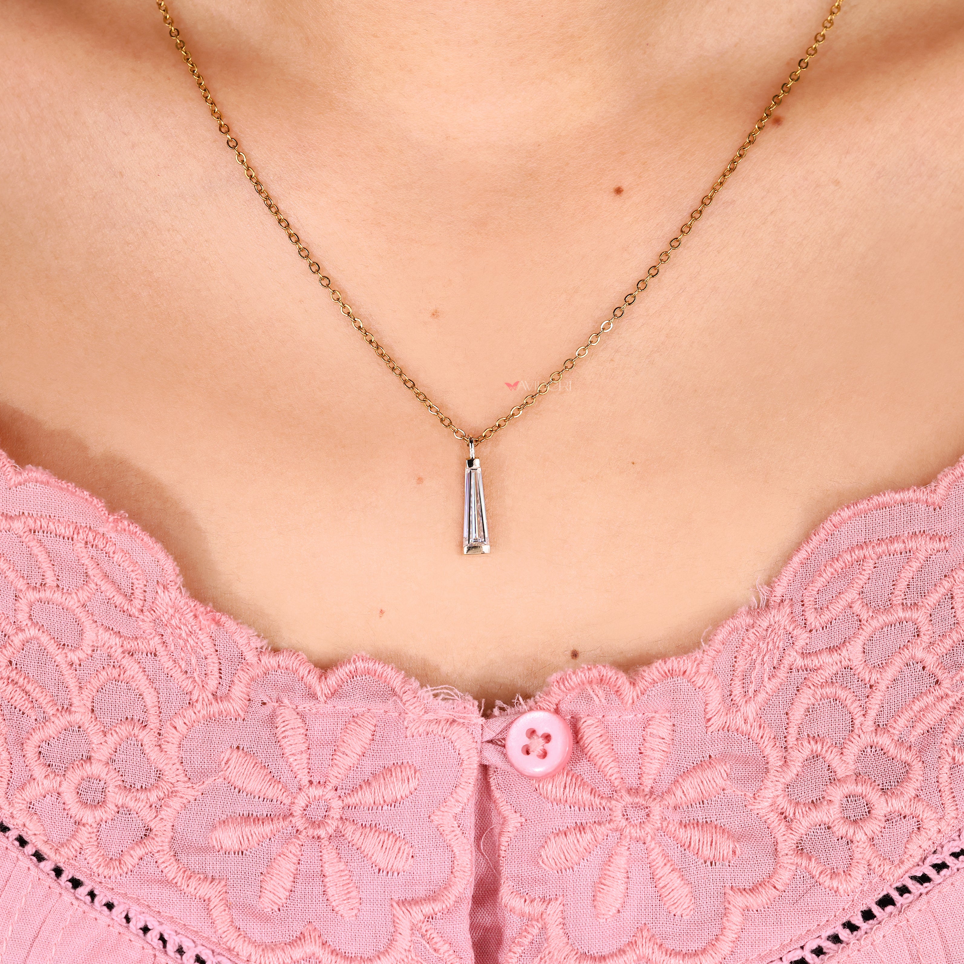 Moissanite pendant with baguette cut side stone accents.
