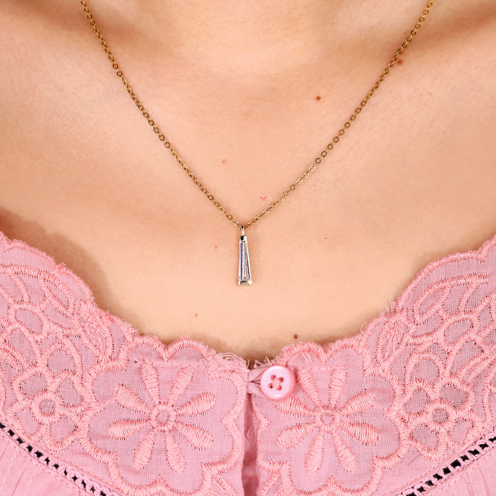 Moissanite pendant with baguette cut side stone accents.
