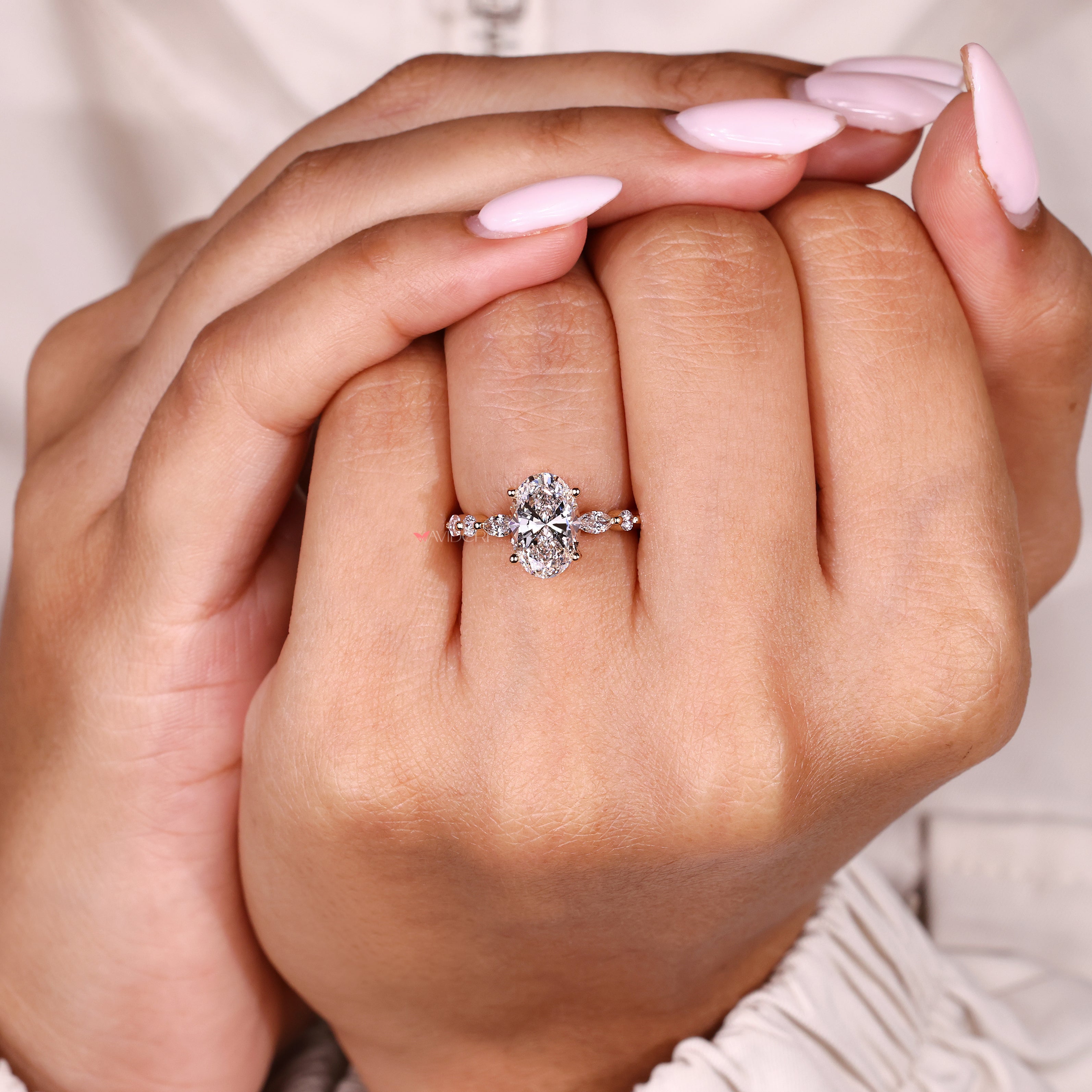Handmade oval diamond ring with round and marquise stones
