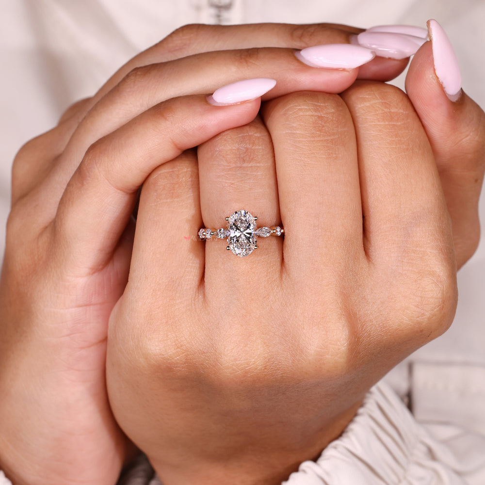 Handmade oval diamond ring with round and marquise stones
