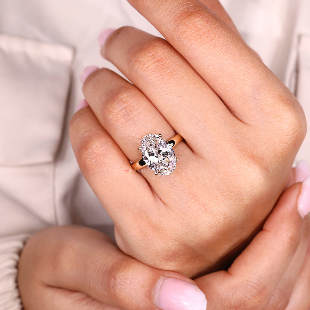 Oval cut lab grown diamond ring with hidden halo.
