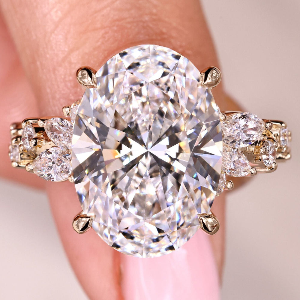 Oval cut diamond ring with marquise and round side stones.
