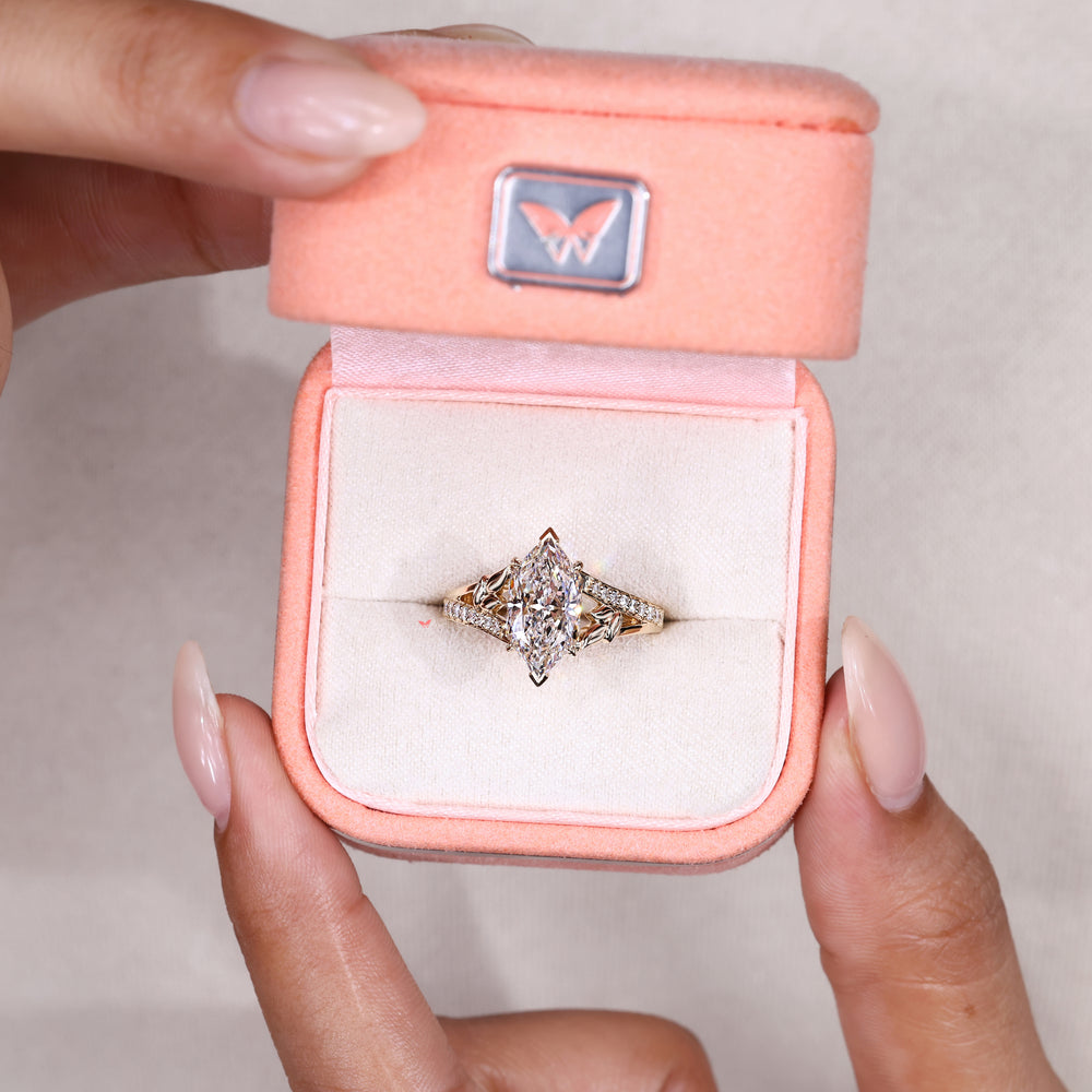 Split shank marquise ring with round diamonds.
