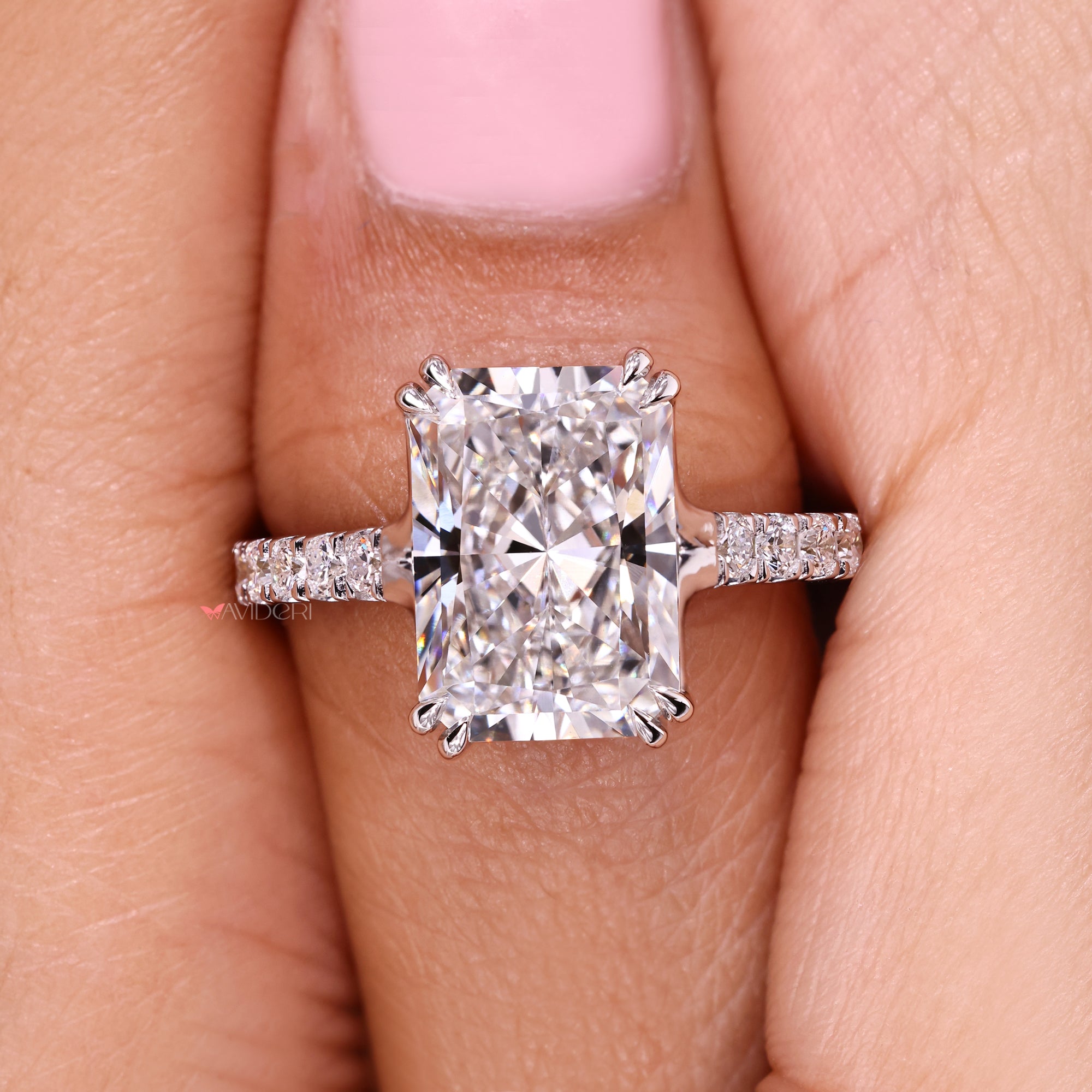 Radiant cut diamond ring with refined trellis setting style.
