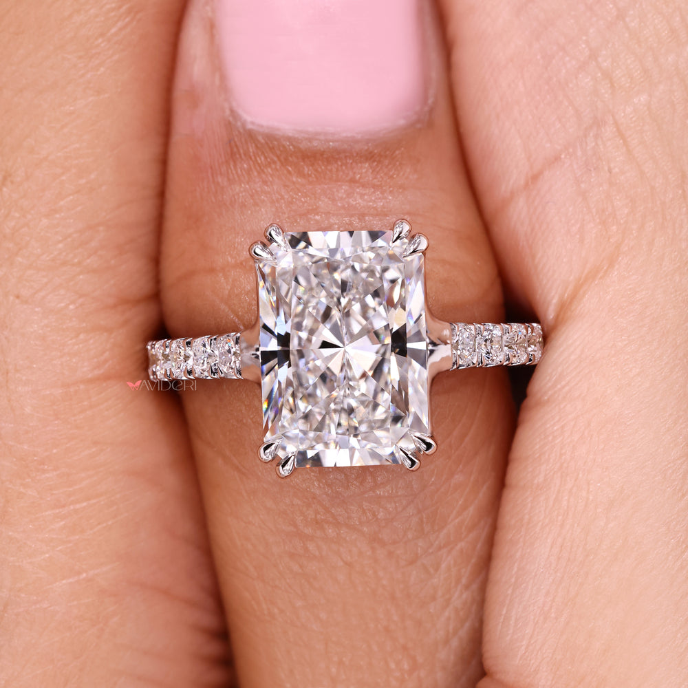 Radiant cut diamond ring with refined trellis setting style.
