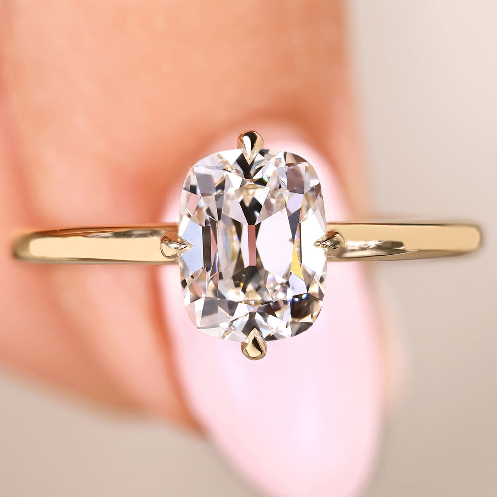 Cushion OEC diamond ring with hidden halo and open gallery

