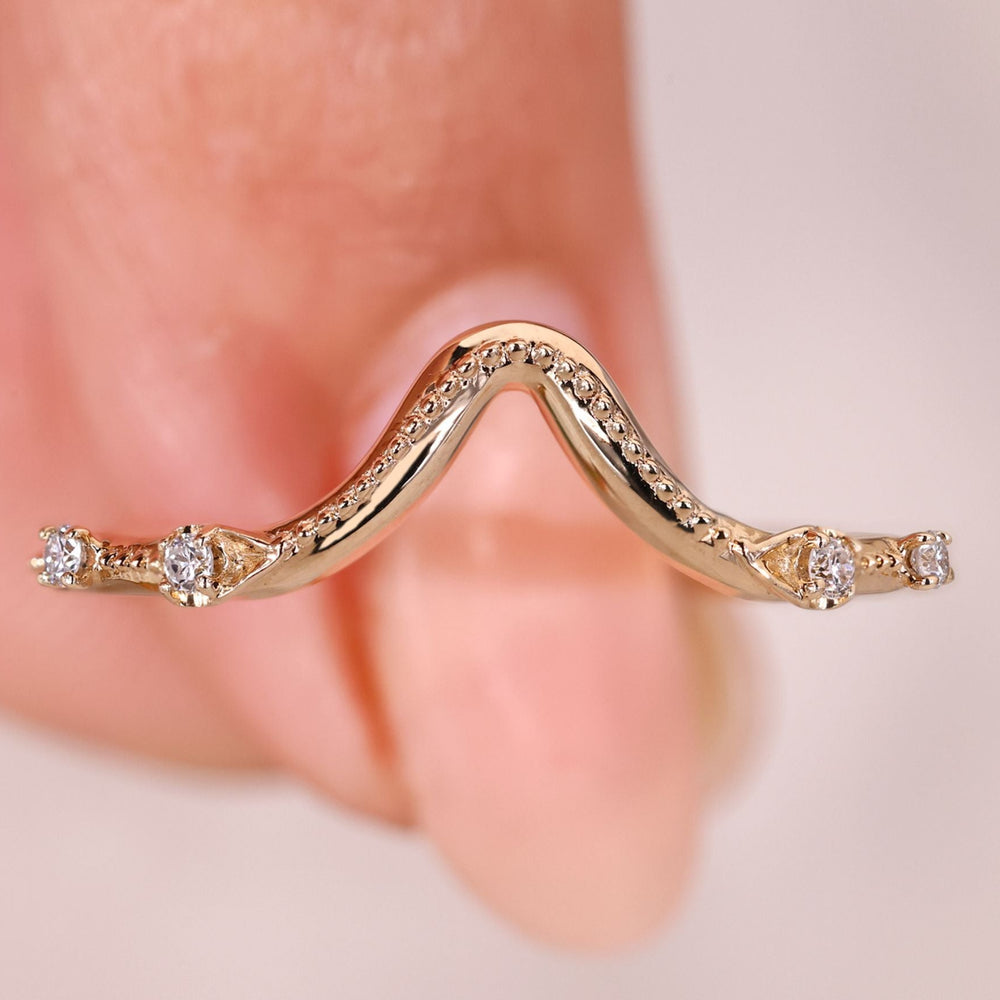 Round diamond curved wedding band with milgrain setting.