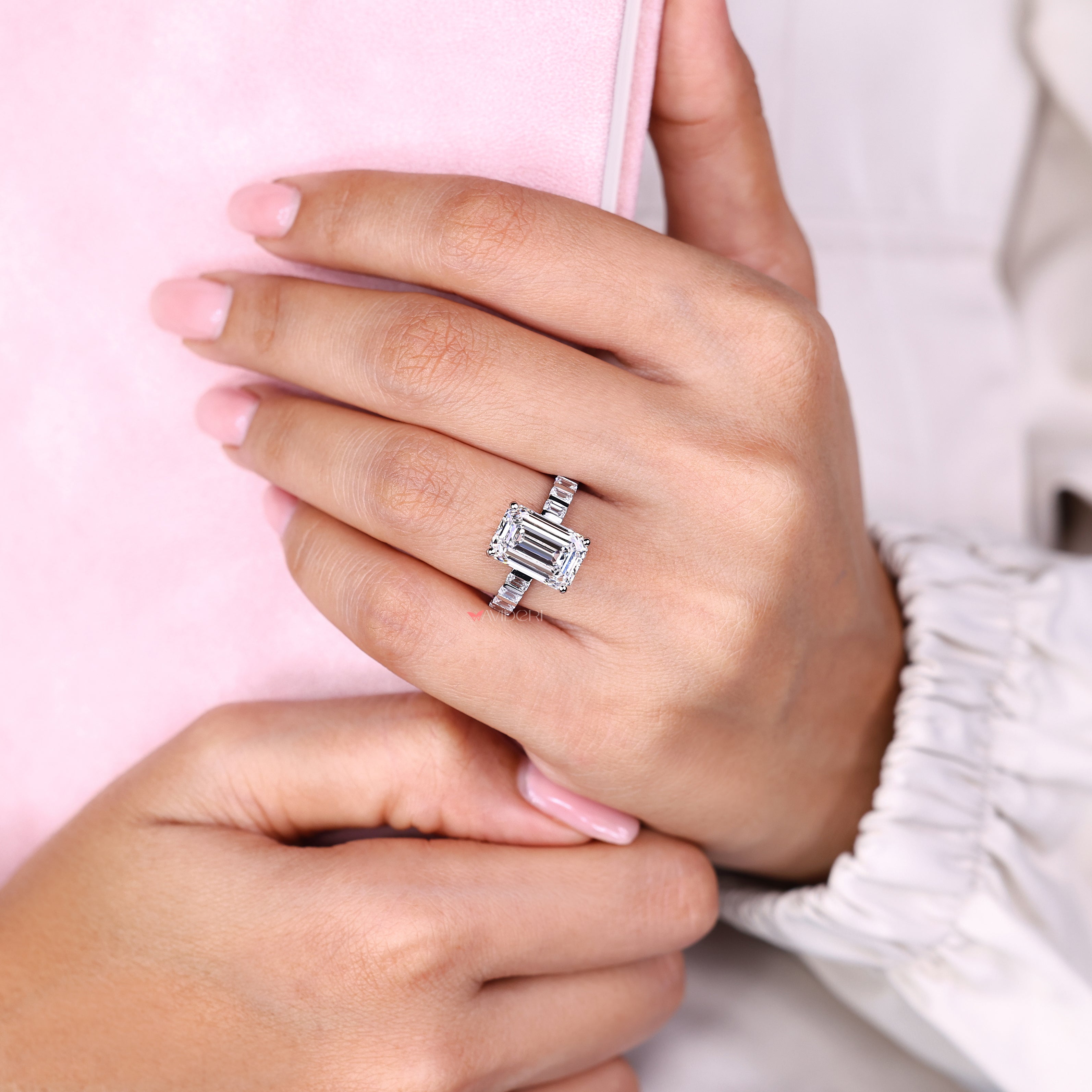 Emerald cut diamond ring with small emerald side diamonds
