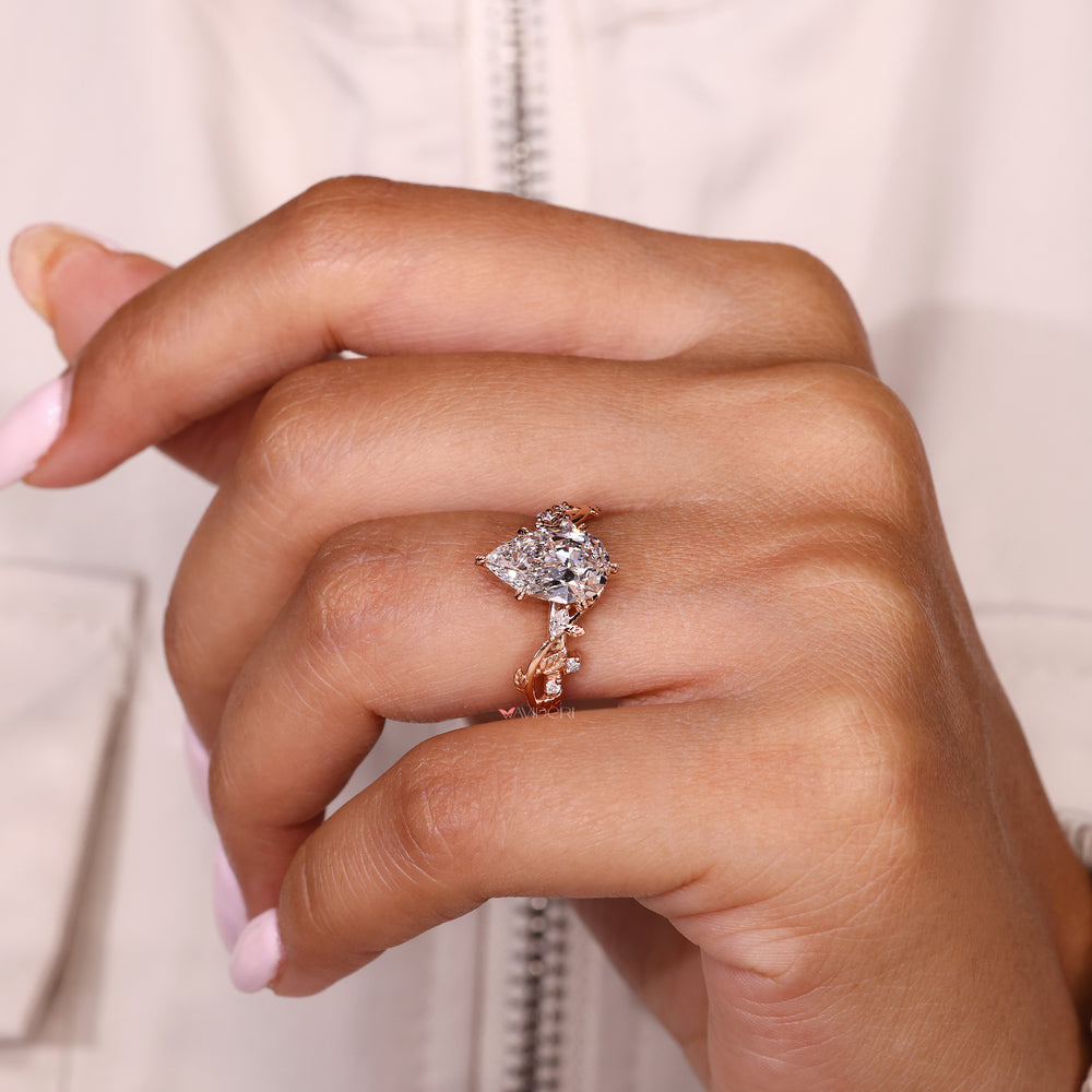Handmade pear shaped diamond ring with marquise side stones
