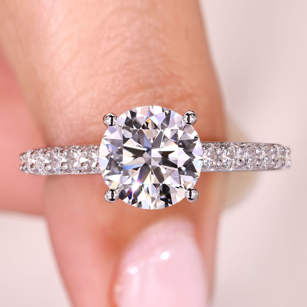 Round diamond engagement ring with hidden halo.
