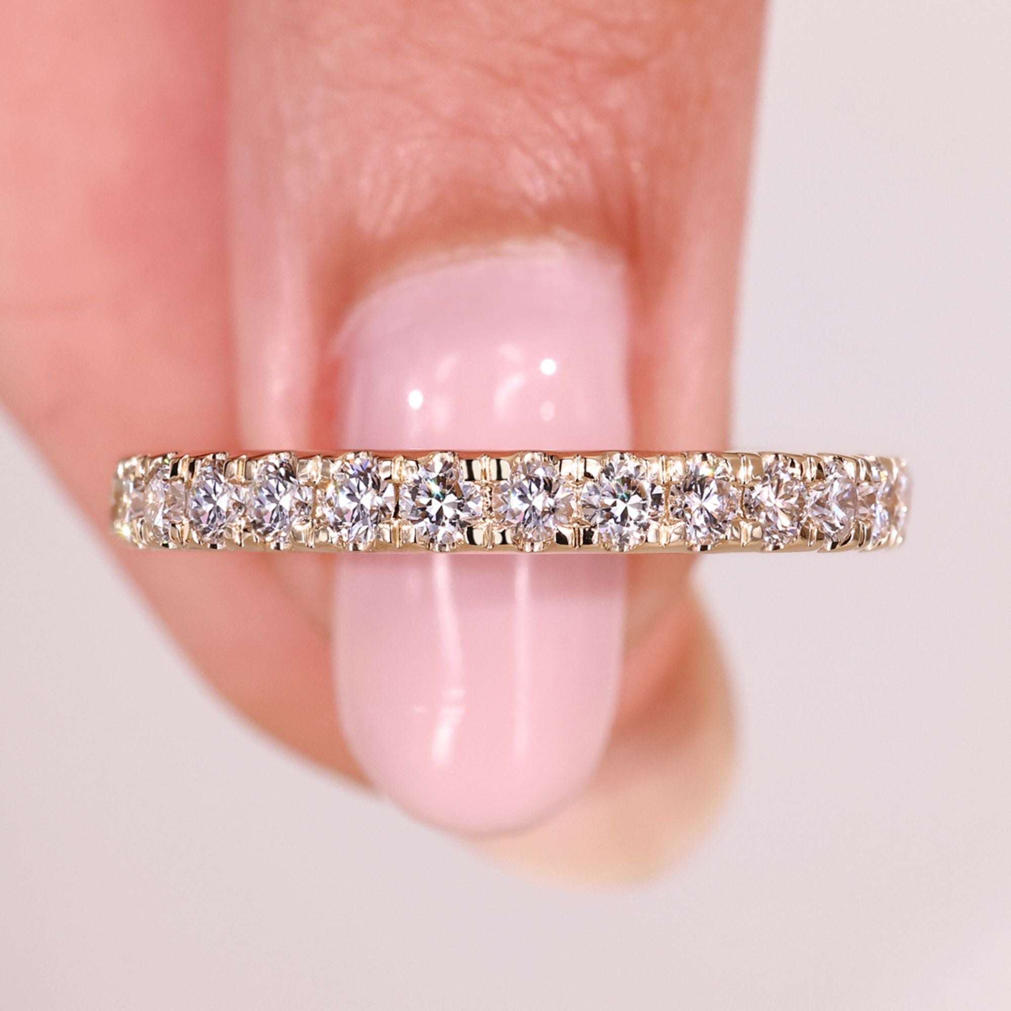 Round diamond half eternity band with prong setting.
