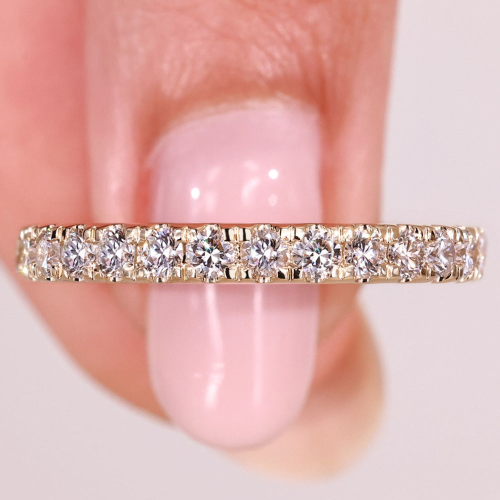 Round diamond half eternity band with prong setting.
