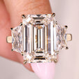 Emerald cut engagement ring with trapezoid side stones design
