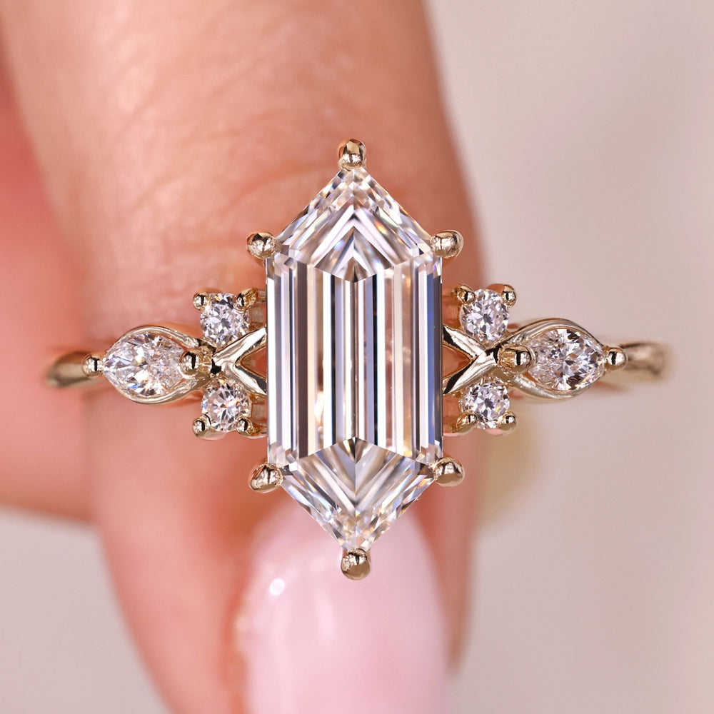Hexagon step cut diamond ring with side stones.

