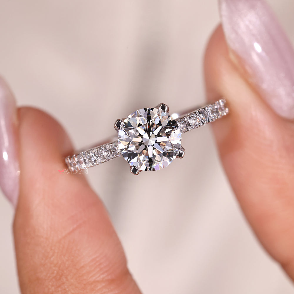 Gift for her, a round diamond ring set in a classic white gold band.
