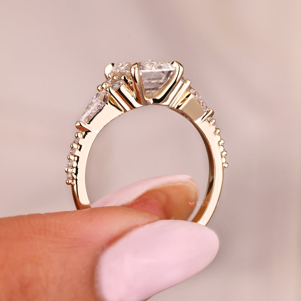 Emerald cut ring with muse setting and round diamonds
