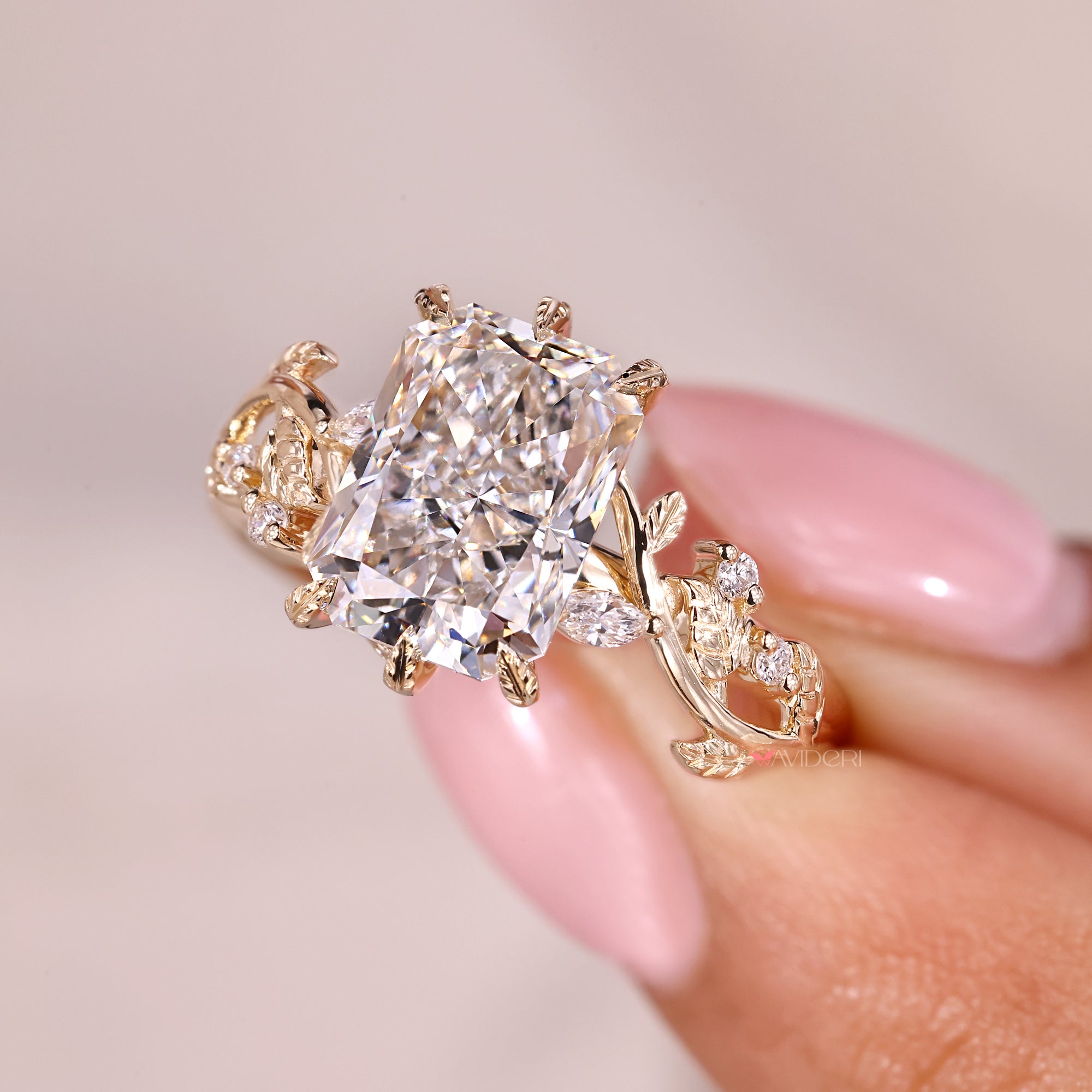 Filigree engagement ring with marquise and round side stone.
