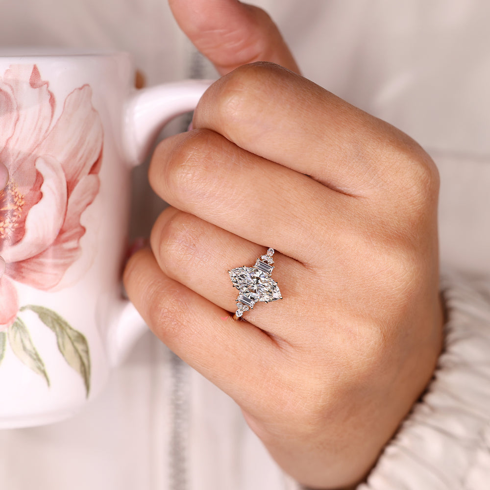 Marquise diamond ring with round baguette side stones.
