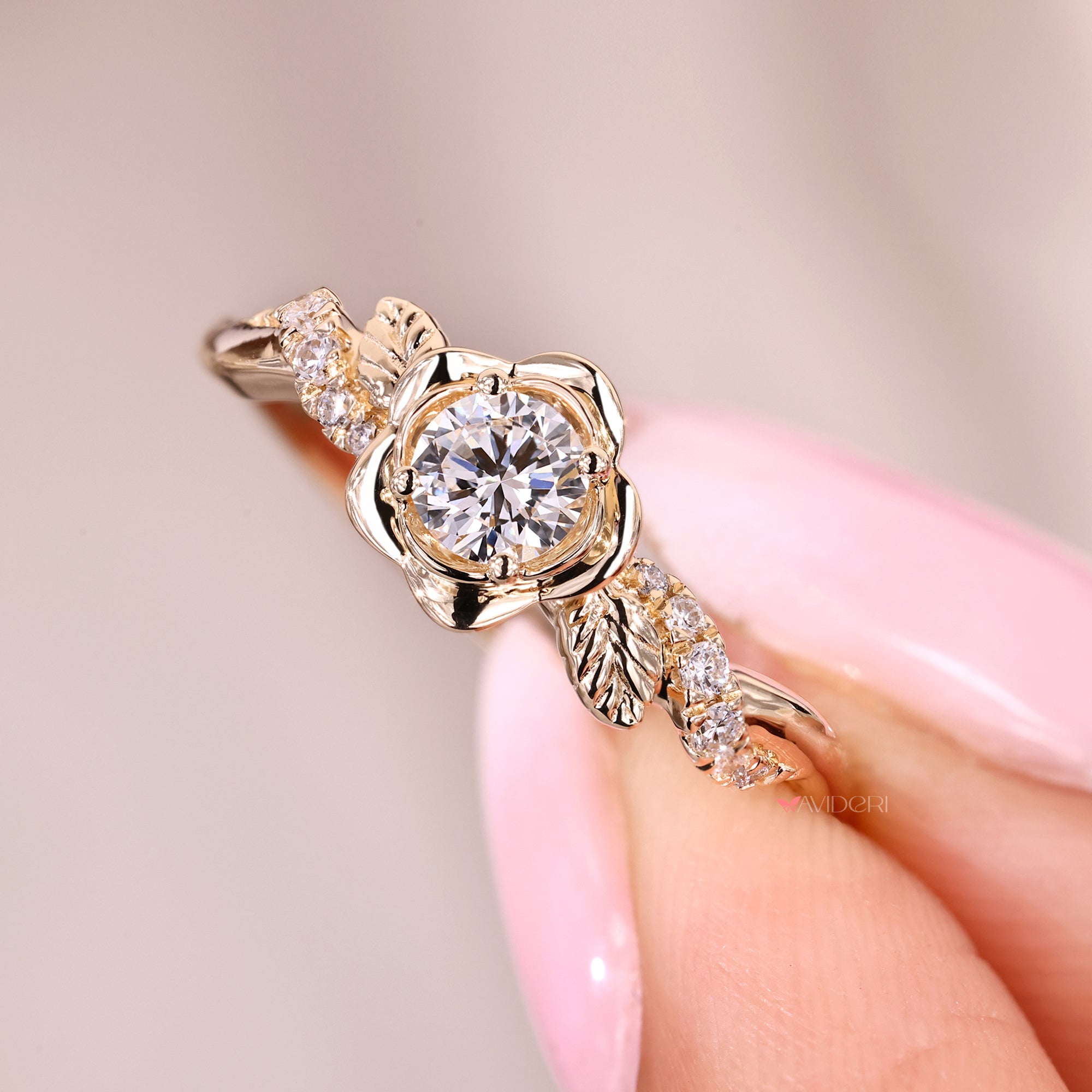 Designer engagement ring with floral detailing and pave-set side diamonds.