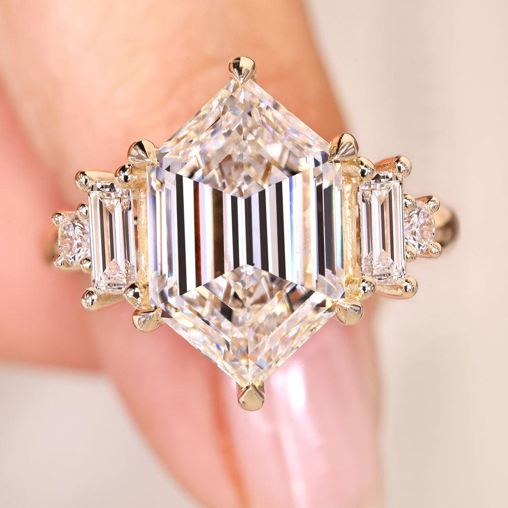 Hexagon cut diamond ring with baguette side stones.
