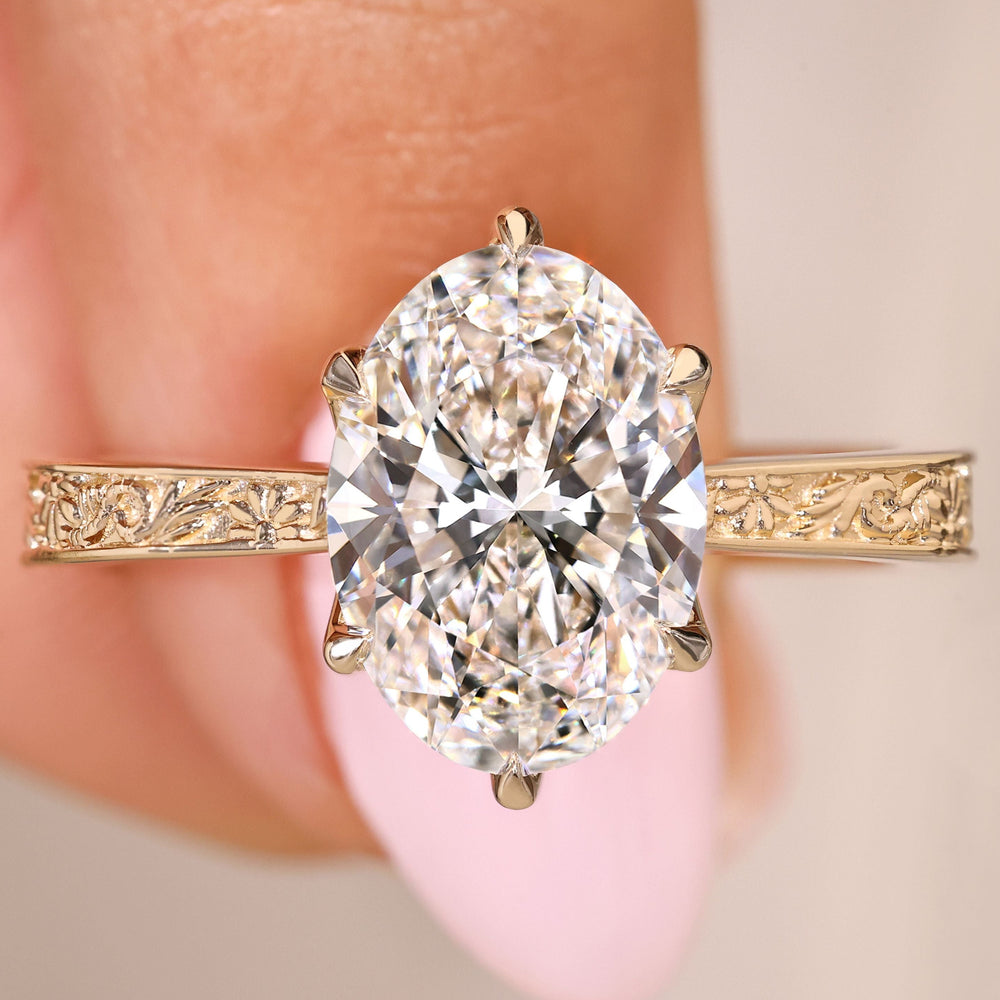 Oval diamond ring with pink ruby and hidden halo