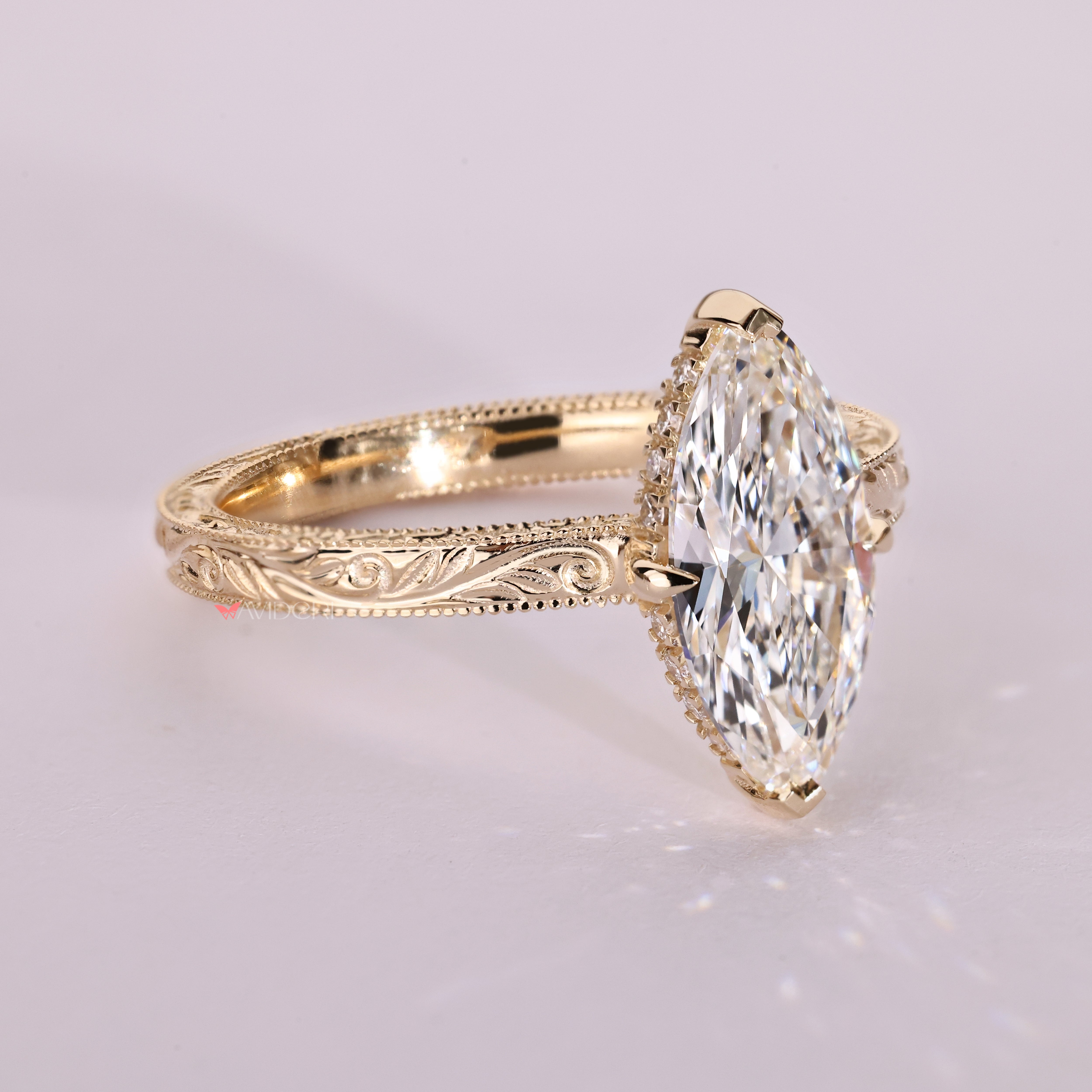 Handmade marquise ring with hidden round diamond halo.
