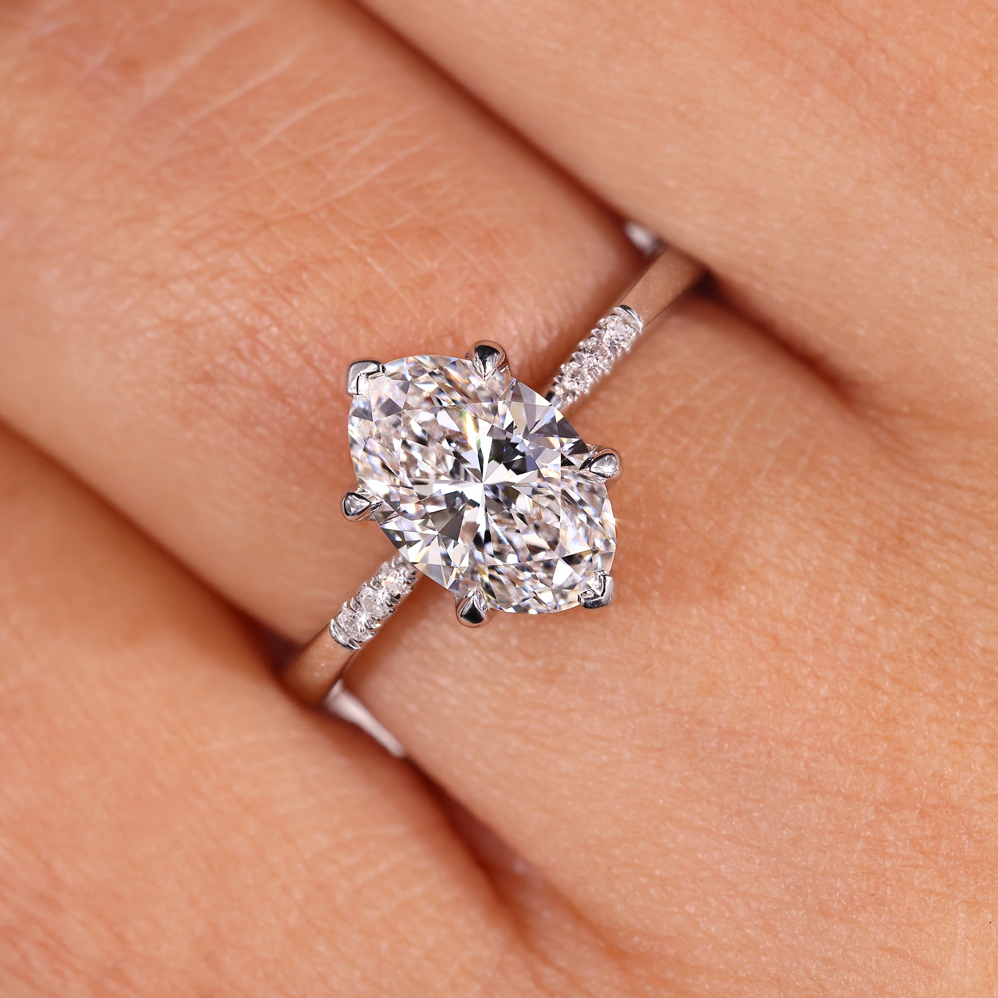 Buy oval diamond ring with round side accents.