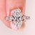 Moval diamond ring with marquise and round side stones.
