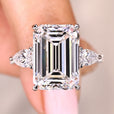 Emerald cut diamond engagement ring with pear side stones.
