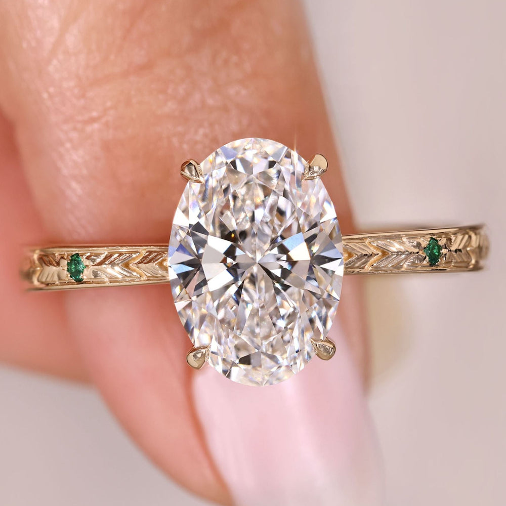 Oval cut diamond ring with hidden halo design.
