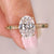 Oval cut diamond ring with hidden halo design.
