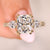 Cushion cut diamond ring with pear side stones.

