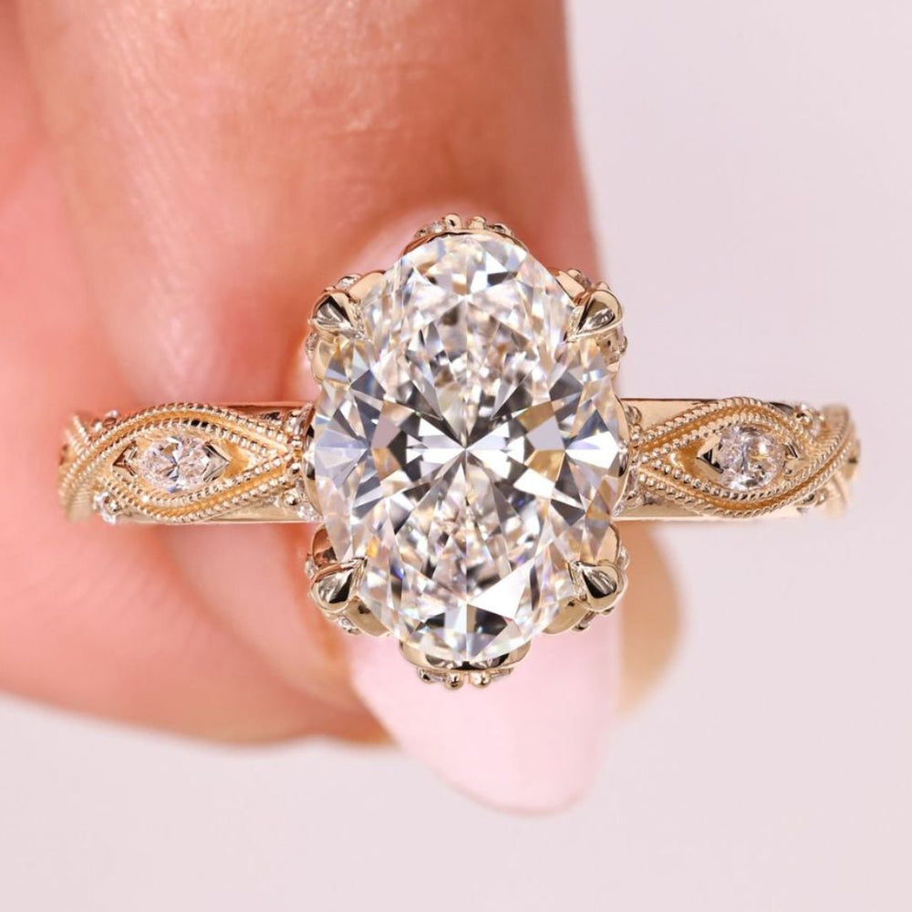 Oval diamond ring with marquise round side stones.
