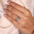 Six claw prong setting engagement ring with a round diamond, ensuring a secure fit.