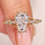 Elongated shield cut diamond ring with round side stones.
