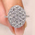 Round lab grown diamond ring with pave cluster setting.
