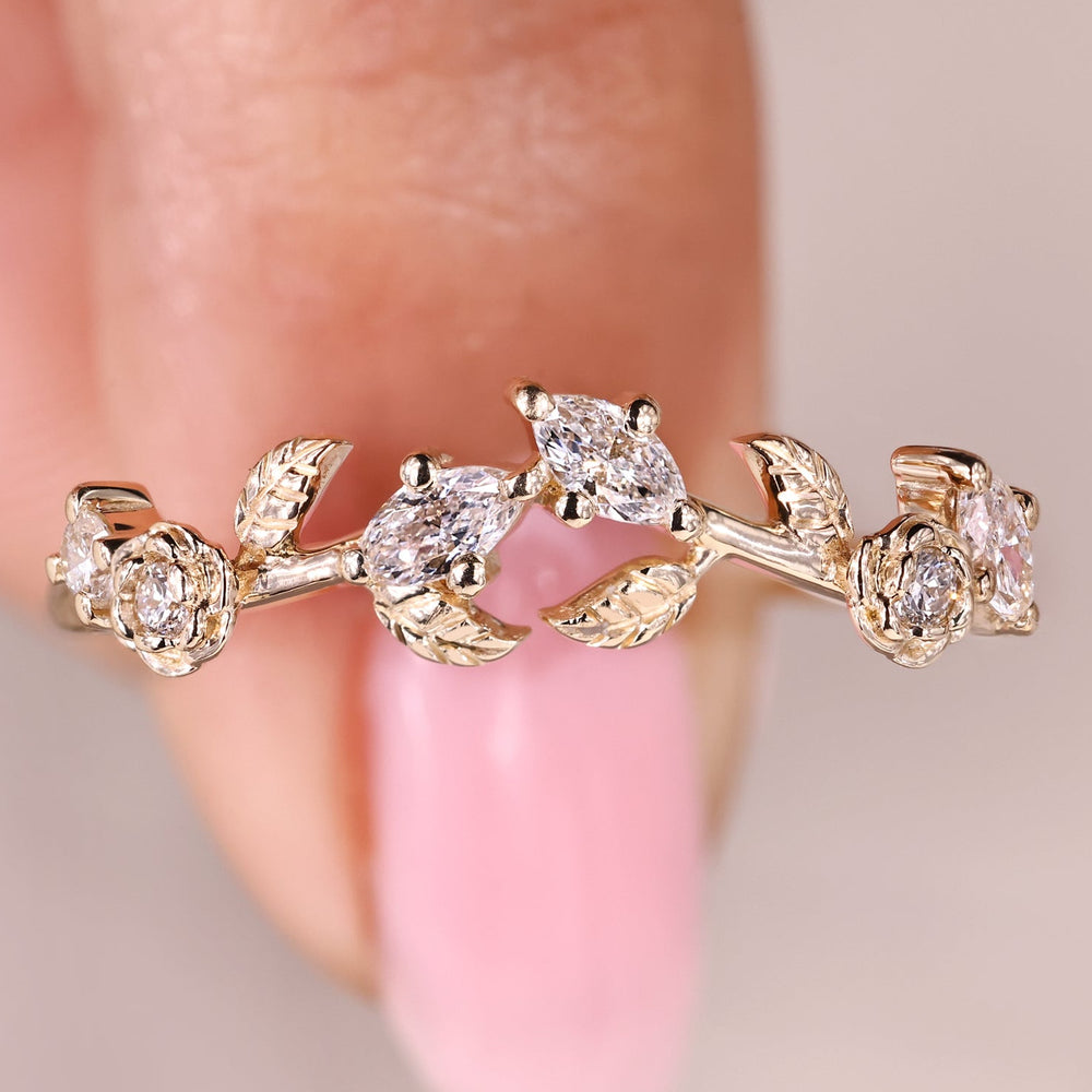 Nature inspired lab grown diamond wedding band with marquise and round stones.