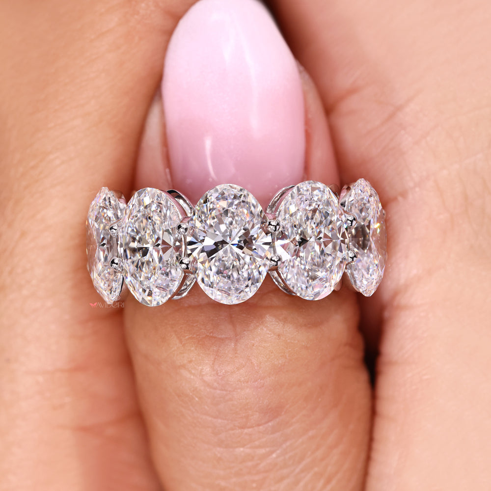 Shared prong oval cut diamond band.