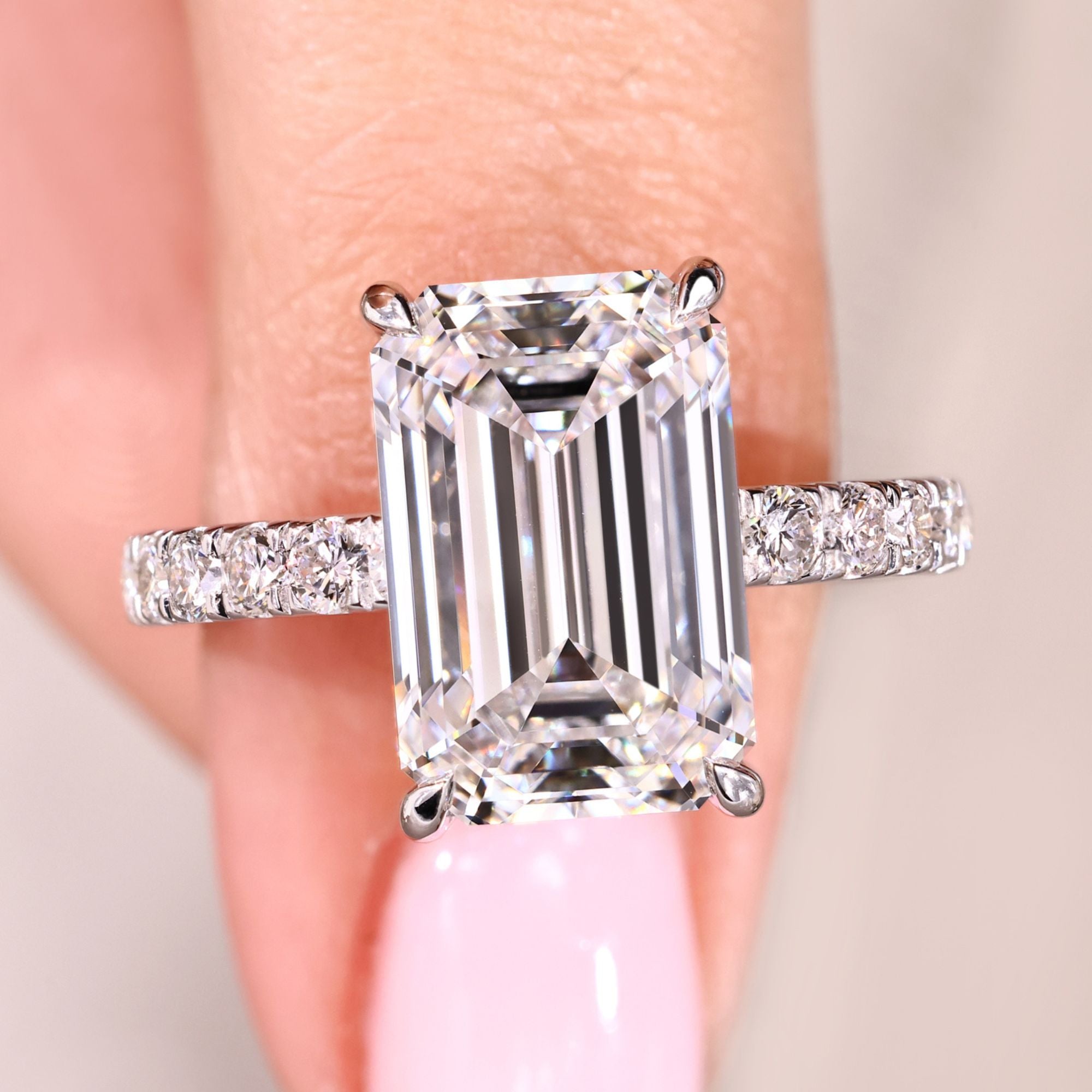 Avideri emerald cut diamond ring with pave setting.
