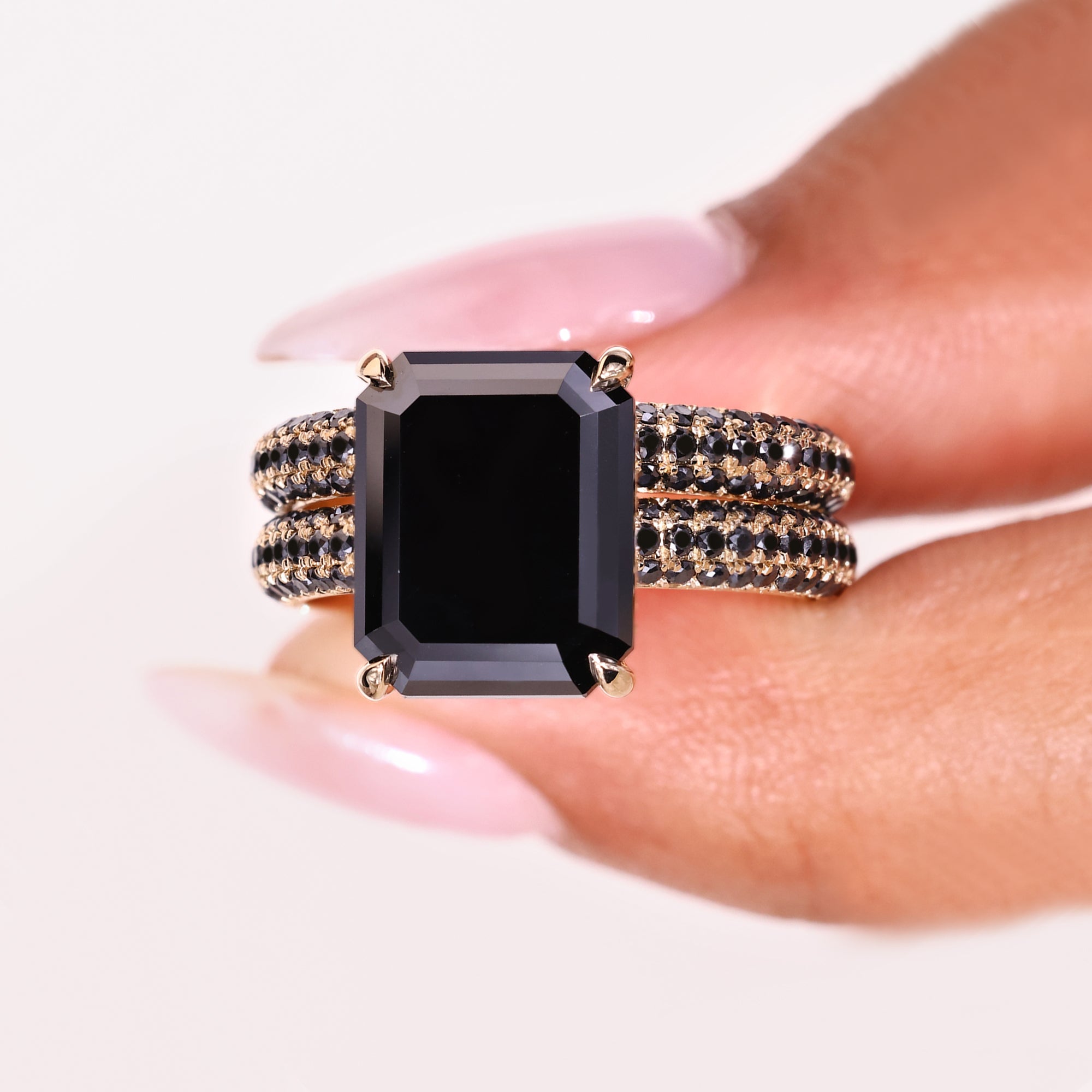 Round cut ring with a stunning emerald cut moissanite center stone.