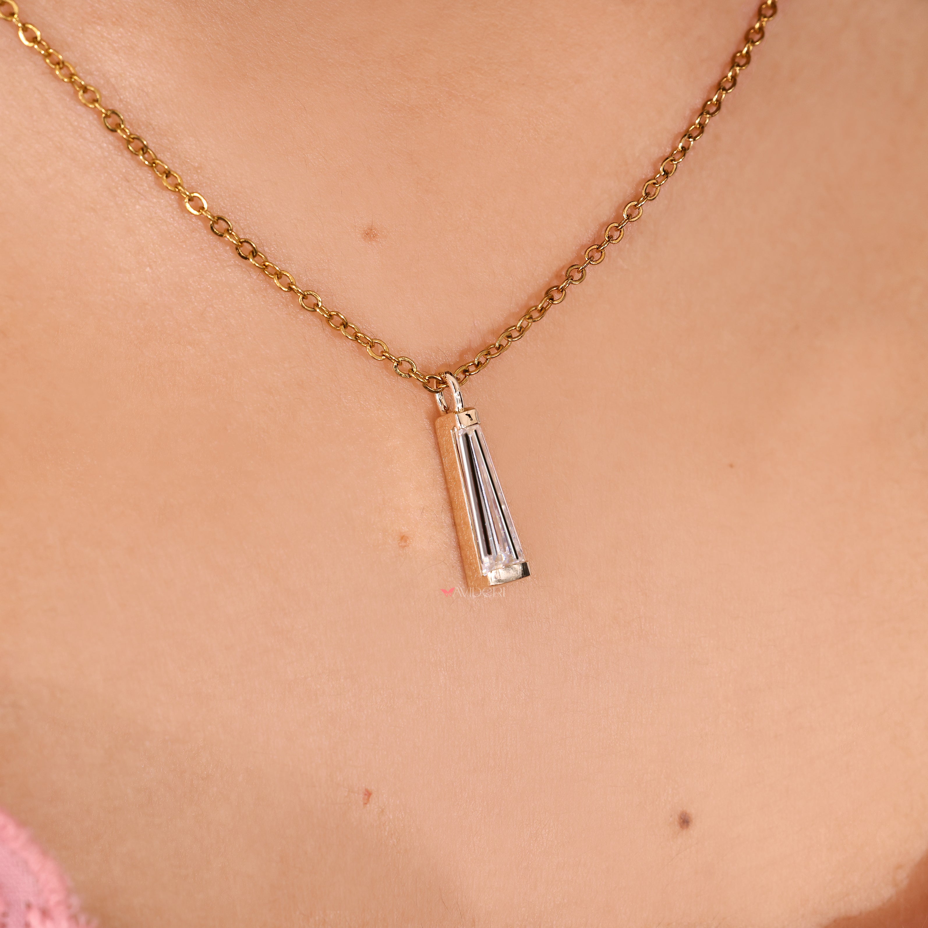 Handmade solitaire pendant with tapered baguette moissanite stones.
