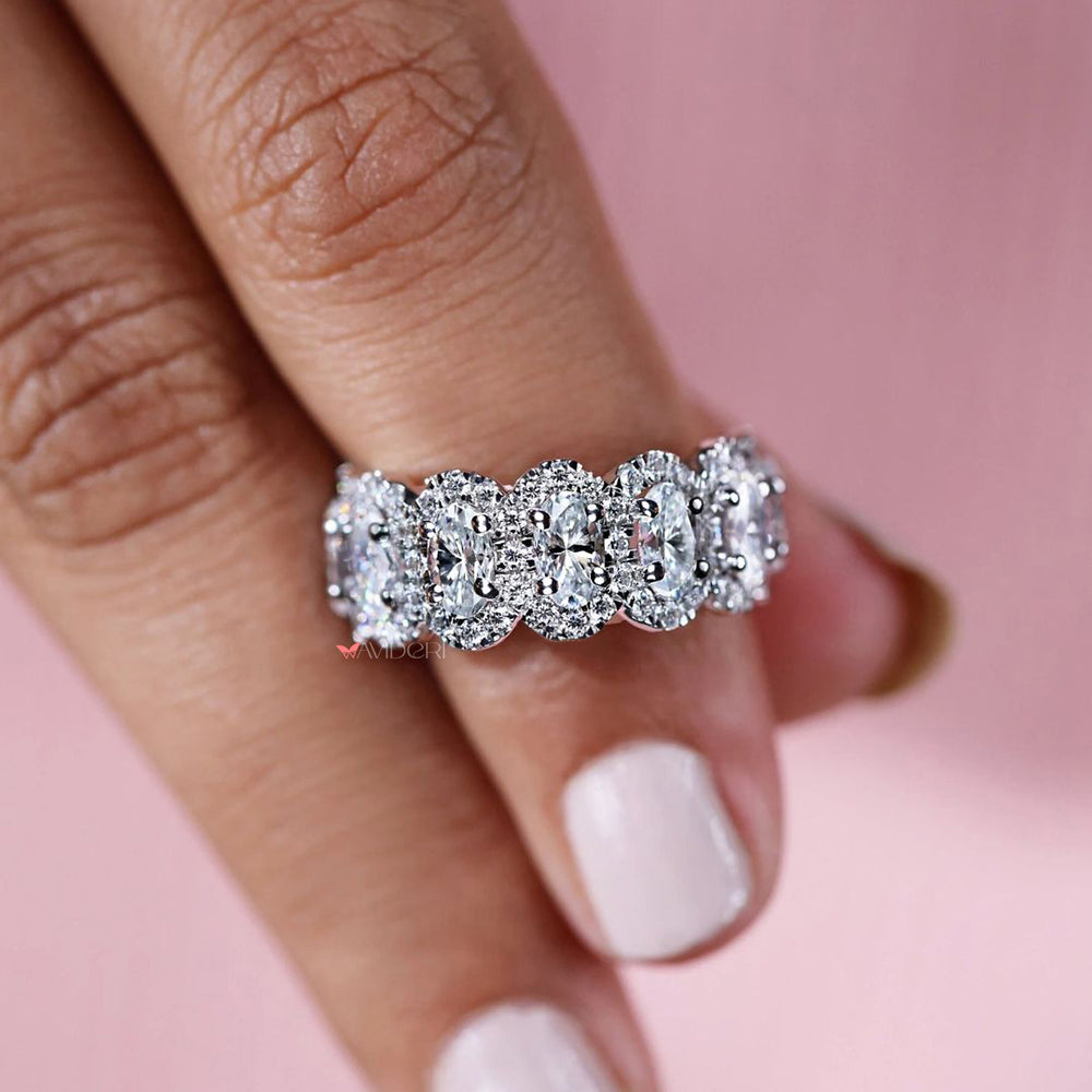 Oval cut wedding band with refined moissanite halo.