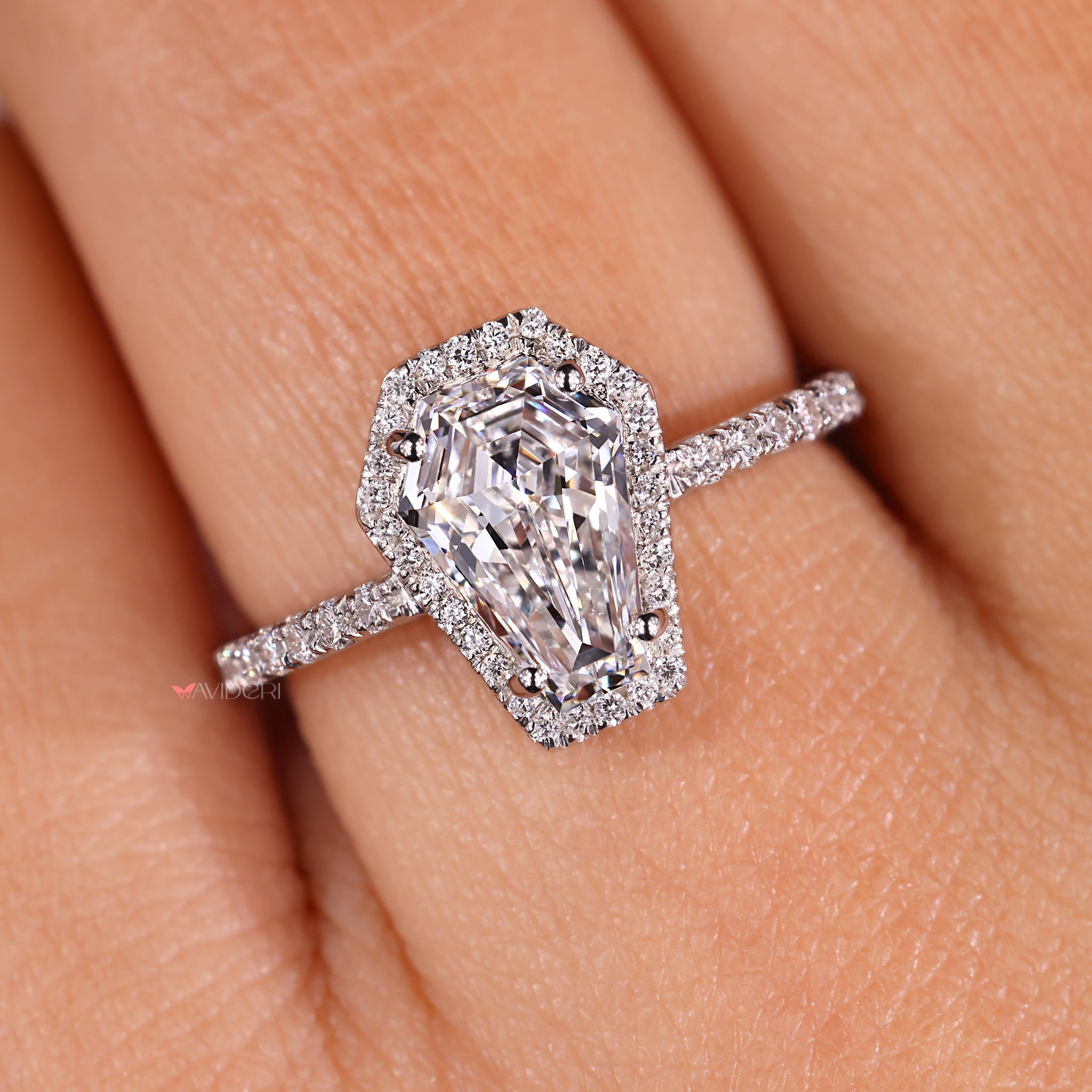 Unique engagement ring with a round cut diamond and pave setting.